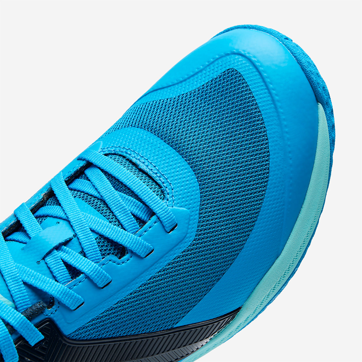 Blue athletic shoe with a focus on the mesh material and laces.