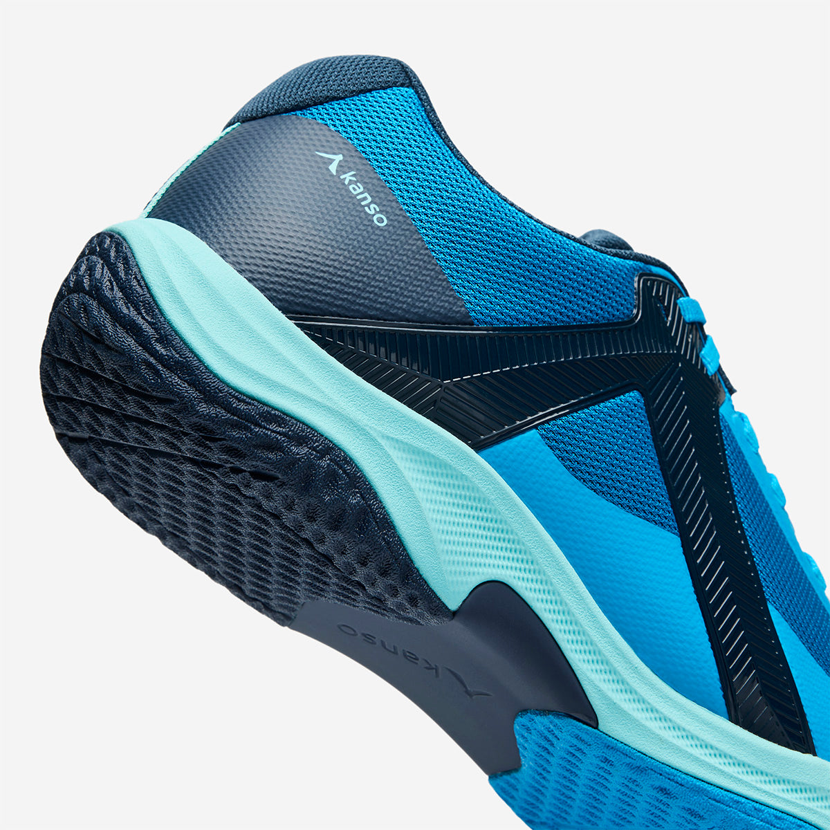 Blue and Navy athletic shoe with brand logo on a white background